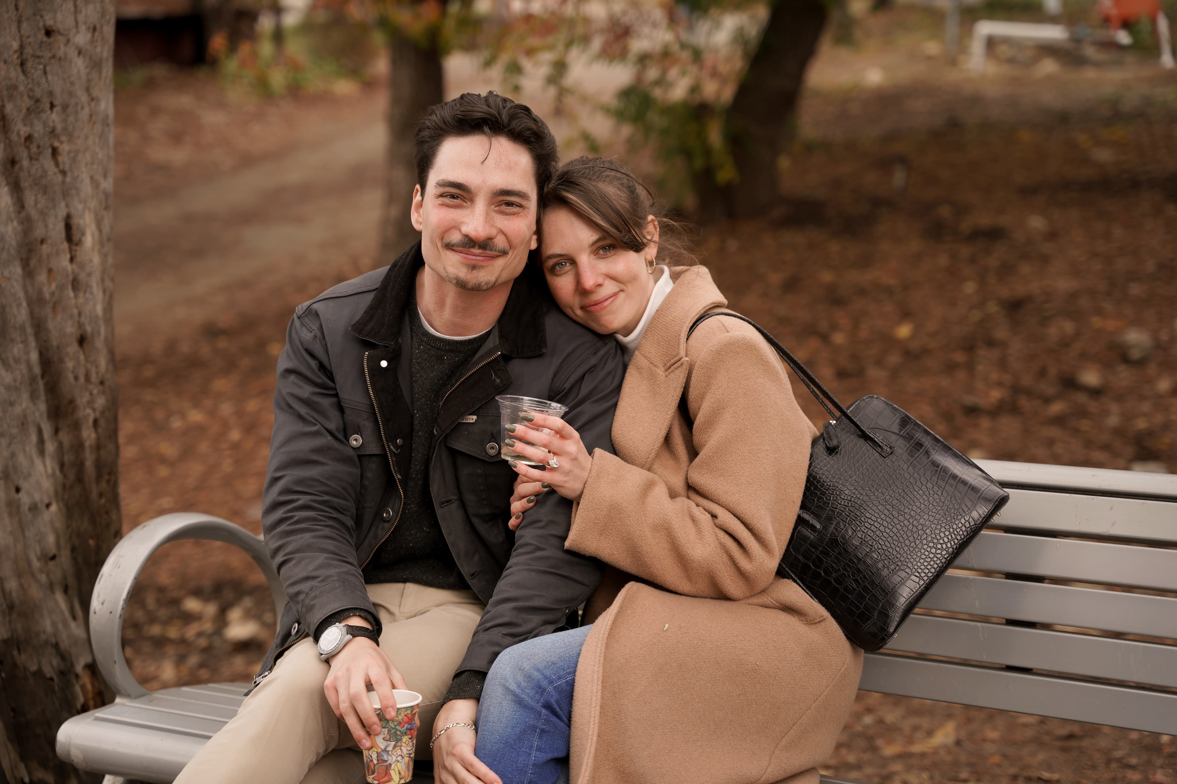 Jax and Jo leaning close together on a bench